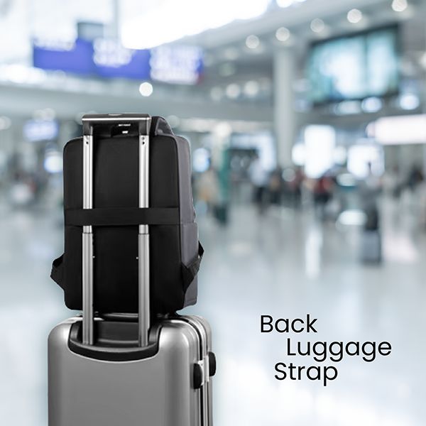Black laptop backpack fixed to a suitcase handle by its back luggage strap in an airport hall