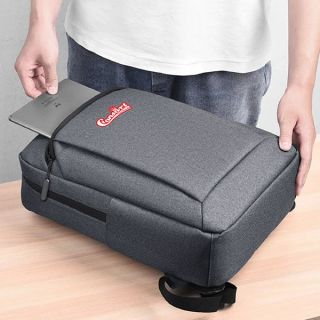 Person sliding a laptop into the top opening of a grey oxford laptop backpack printed with a logo