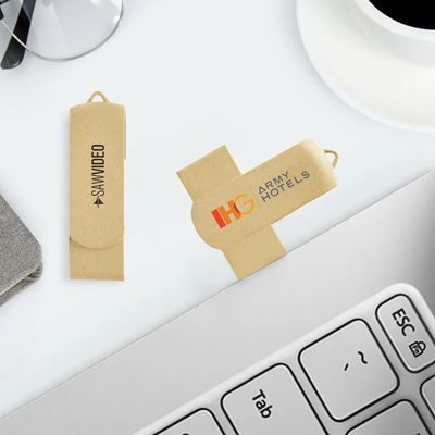 Two beige eco swivel drives printed with a logo lying beside a laptop keyboard and a coffee cup