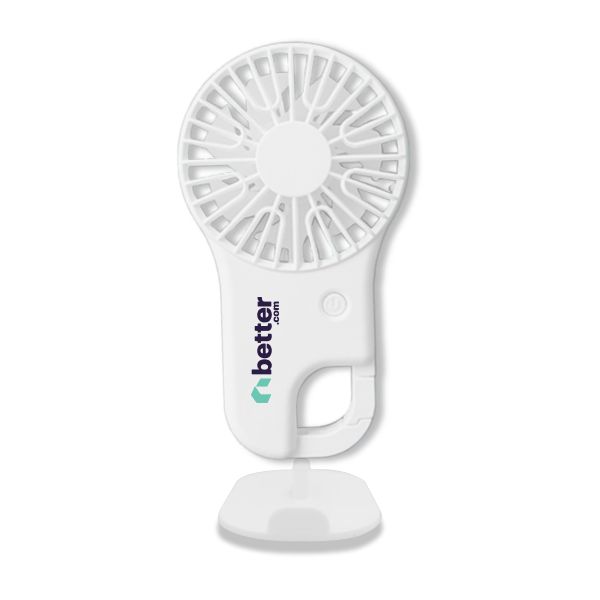 White handheld fan printed with a logo, standing upright on its fold-out base with the blade guard facing forward.