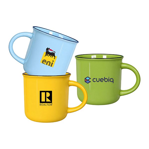 Stacked light blue and yellow ceramic mugs beside a green one, all with a dark rim line and a logo printed on the side