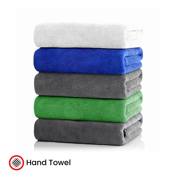 A stack of folded microfiber towels in white, blue, grey, green and dark grey, marked with a hand towel badge.