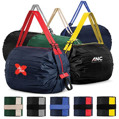 Rolled-up foldable bags in navy, green and black with red, tan, yellow and blue webbing handles, over five folded colour swatches.
