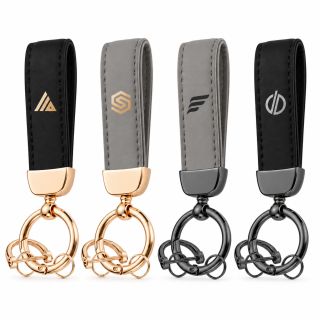 Four PU key straps in black and grey with rose gold and gunmetal key rings, each printed with a logo.