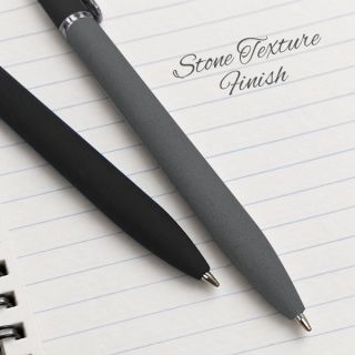 Black and grey stone-texture pens lying on a lined notebook page
