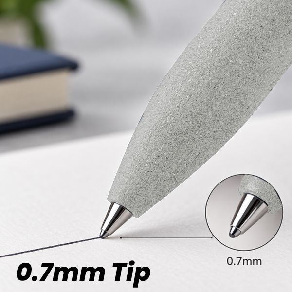 Close-up of the light grey stone-texture barrel and 0.7mm ball point tip drawing a line