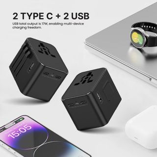 Two black travel adapters beside a laptop, smartwatch, phone and earbuds, with the text 2 Type C + 2 USB