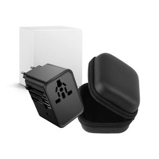 Black travel adapter and its zip carrying case in front of a plain white gift box