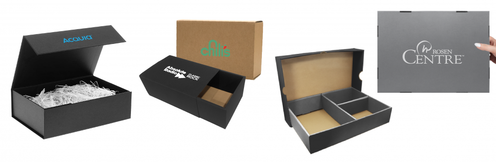 Black magnetic lid gift box filled with white shredded paper, a kraft and black slide gift box, and a two-compartment gift box, each printed with a logo